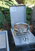 Outdoor cooking setup with a single side burner and pan on a patio