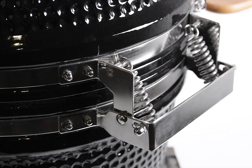 Close-up of a black kamado of lid springs