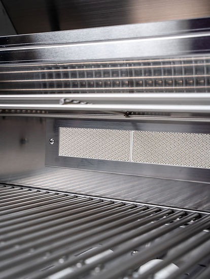 Close-up of a stainless steel grill with mesh cover