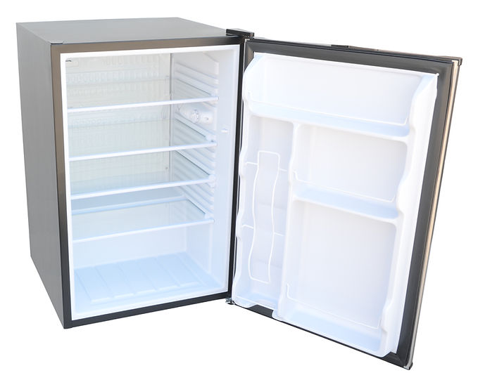 Small refrigerator with open door on a white background