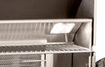 Stainless steel grill with glowing light inside a kitchen setting