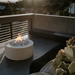 Fire pit on a rooftop with cityscape in the background