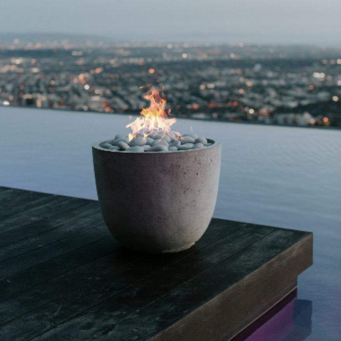 Fire pit with a view of a city skyline at dusk
