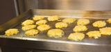 Baked goods on a metal tray in a kitchen setting